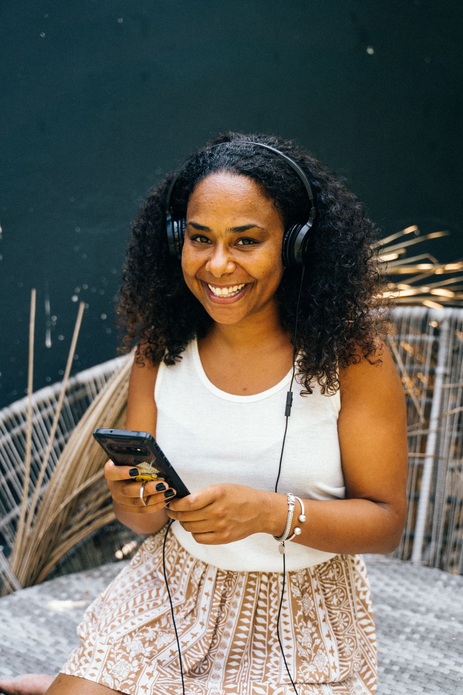 Listener with headphones and phone